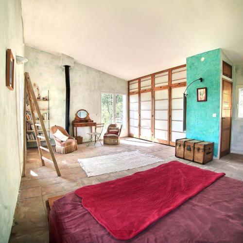 a room with a bed and a table in it at House Pool Out In The Wilds in Salernes