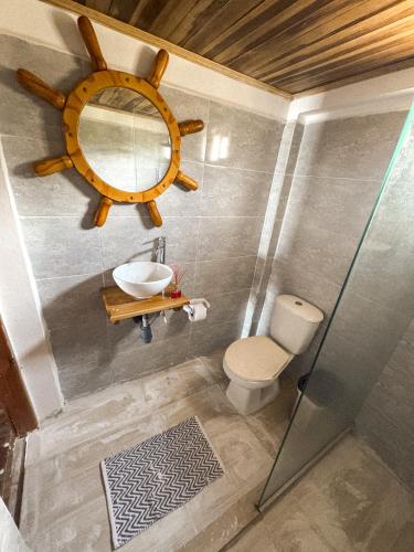 a bathroom with a sink and a mirror on the wall at Cabaña Kokkos Del Mar in Santa Marta