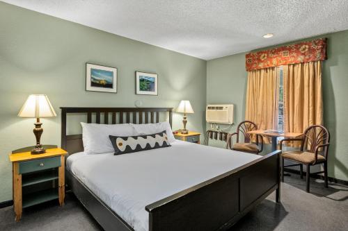 a bedroom with a bed and a table and chairs at Old Town Inn in Crested Butte