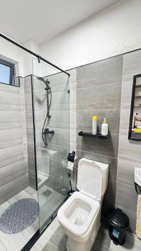 a bathroom with a toilet and a glass shower at Nene Homes in Marimbeti