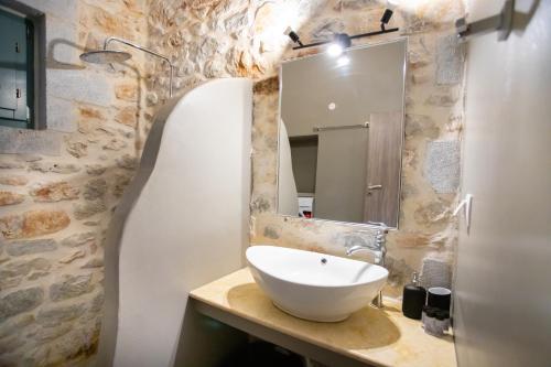 a bathroom with a sink and a mirror at Mainotti's house with balcony in Areopoli