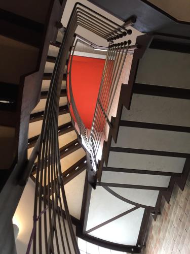 a spiral staircase in a building with a red wall at La Mansarda di Margherita in Treviso
