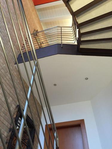 a spiral staircase in a building with a stair case at La Mansarda di Margherita in Treviso