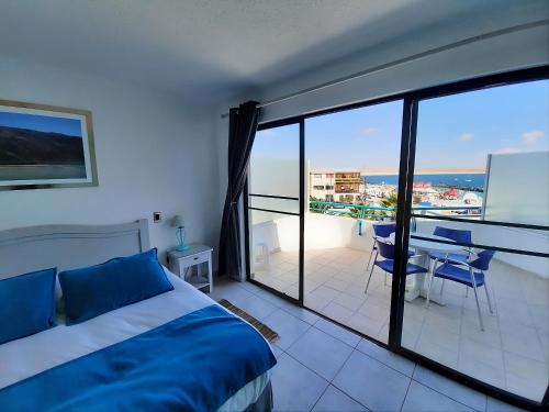 a bedroom with a bed and a view of the ocean at Hotel Rocas de Bahía in Bahia Inglesa
