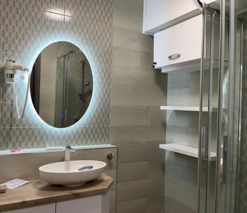 a bathroom with a sink and a mirror at Lakeside Apartment Sunset Resort in Fonyód