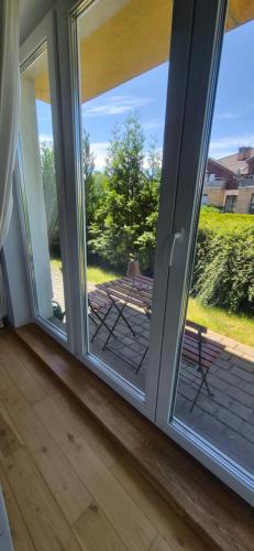 a sliding glass door with a view of a patio at Apartament Maciejkowa in Szczecin