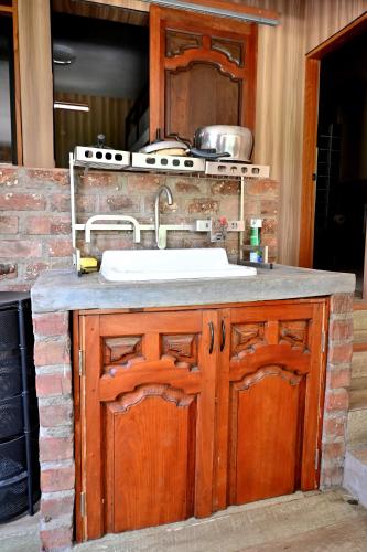 a kitchen counter with a sink and a stove at Chatowasi Mountain Lodge in Santa Eulalia