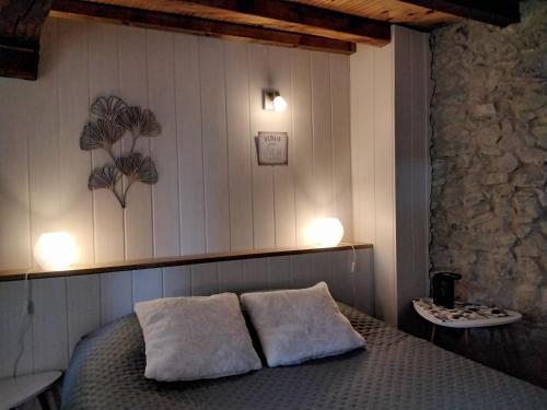 a bedroom with a bed with two pillows on it at Maison de la Source in Leychert