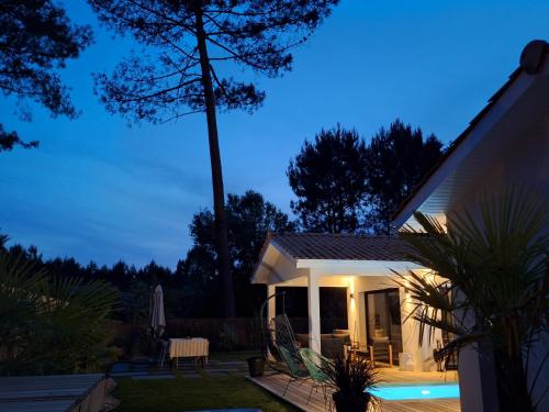 a house with a swimming pool at night at Villa Céline - Prestige, Piscine & Jacuzzi in Vielle-Saint-Girons