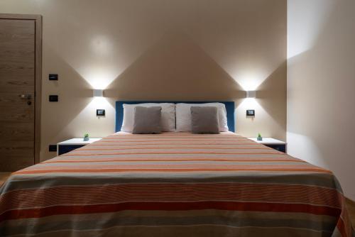 a bedroom with a large bed with two pillows at ISA ROOMS Bed&Breakfast in Bovalino Marina