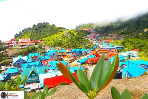 a group of colorful houses on a hill at Hotel sangam kalinchok kuri in Dolakhā