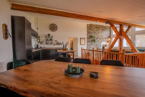 a dining room and kitchen with a wooden table at Starkenburger Perle in Starkenburg