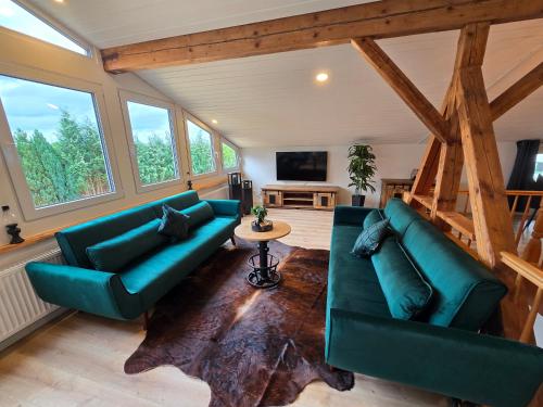 a living room with two blue couches and a table at Starkenburger Perle in Starkenburg