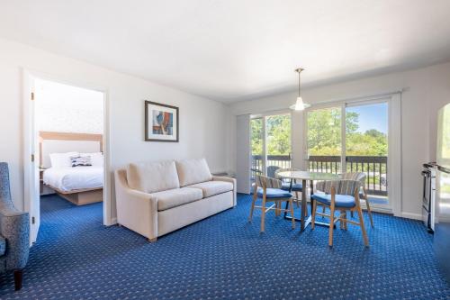 a living room with a couch and a table at Aspinquid Resort in Ogunquit