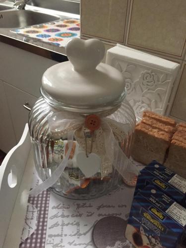 a glass jar with a heart on top of it at Casetta sul Porto in Imperia