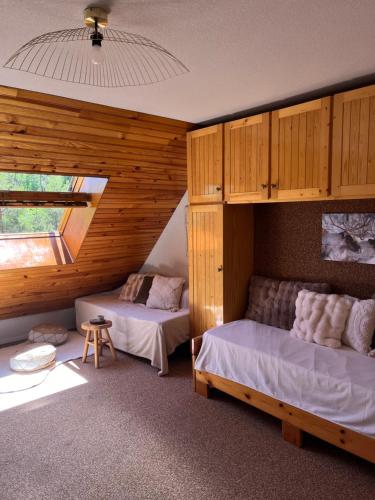a bedroom with two beds and a window at Riviera Lodge II in Allos