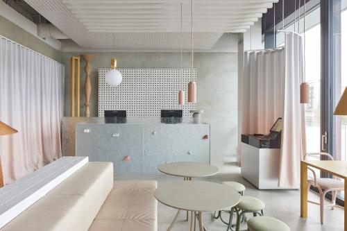 a living room with two tables and a couch at Locke at East Side Gallery in Berlin