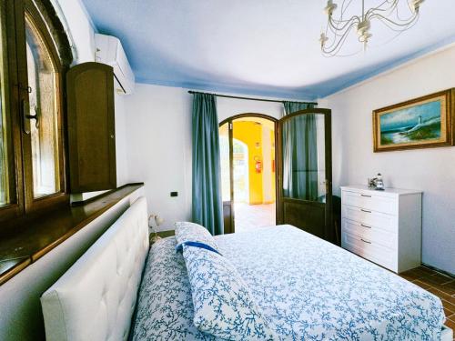 a bedroom with a bed and a dresser at Agriturismo Colle Donatucci in Castagneto Carducci