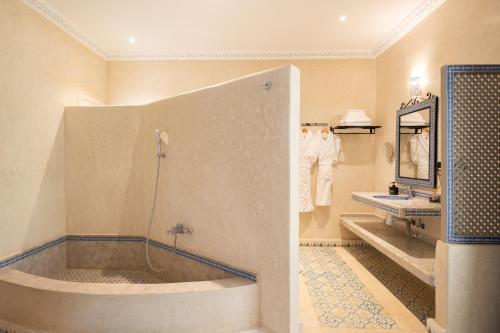 a large bathroom with a tub and a sink at Villa du Cedre in Marrakesh