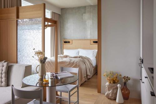 a bedroom with a bed and a table and chairs at Locke at East Side Gallery in Berlin
