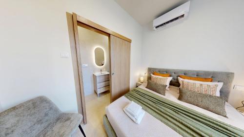 a small bedroom with a bed and a mirror at Lobster Room - Estrela do Mar - 1 in Albufeira