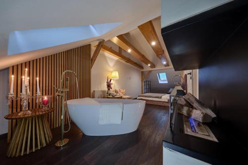 a large bathroom with a bath tub and a bedroom at Luxury Heaven Apartment - 116 m2 Fireplace 3 bedroom - Free Parking in Katowice