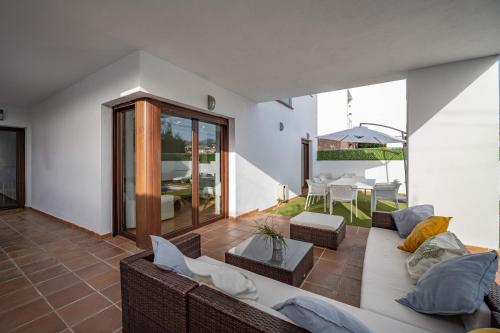 a living room with a couch and a table at VILLA TAZA DE PLATA A in Huétor Vega