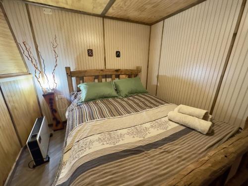 a bedroom with a bed and a tv in it at Oceana Suites Coyhaique in Puerto Dunn