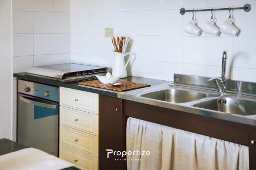 a kitchen with a sink and a counter top at Il terrazzo sulla duna 6 by Propertize in Torre Dei Corsari