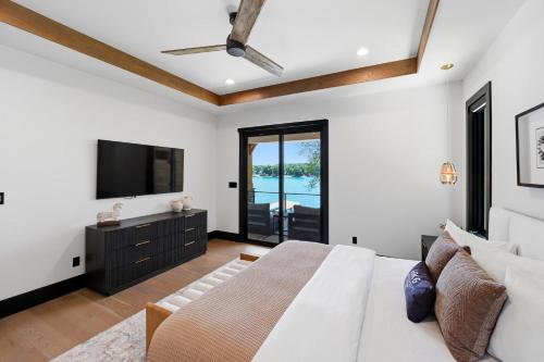 a bedroom with a bed and a flat screen tv at Willow Landing in Troutman