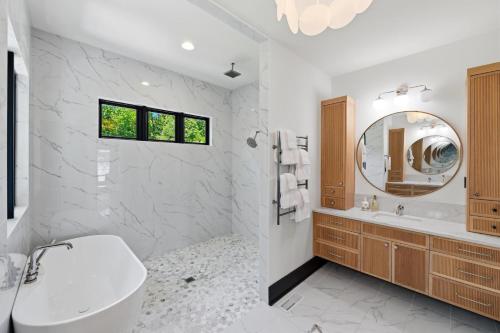 a white bathroom with a sink and a mirror at Willow Landing in Troutman