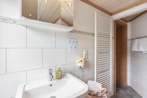 a white bathroom with a sink and a mirror at Ferienhof Pohl-Optimal für Familien in Lennestadt