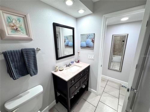 a bathroom with a sink and a toilet and a mirror at 2BR/2BA condo Sienna Park in Sarasota
