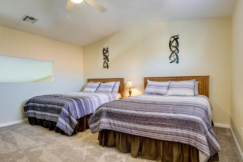 two beds sitting next to each other in a bedroom at Golf & Gamble! Mesquite Condo w/ Pool Access in Mesquite