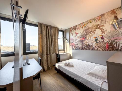 a hotel room with a bed and a desk at Continental Urban Art Hotel in Zola Predosa
