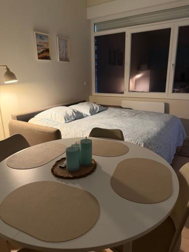 a bedroom with a bed and a table and chairs at Studio des dunes au clocher in Berck-sur-Mer