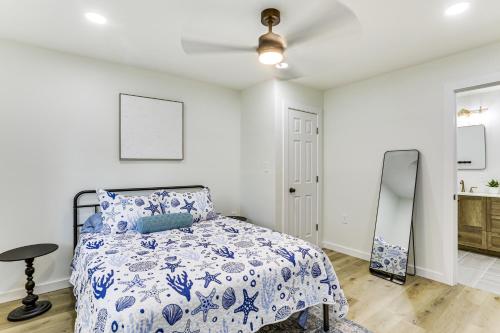 a bedroom with a bed and a mirror at Steinhatchee River Hideaway, 1 Mi to the Water! in Steinhatchee