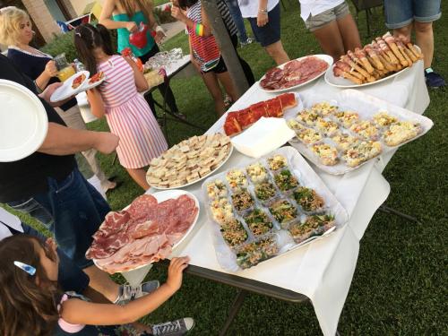 people standing around a table with food on it at Agriturismo Le Rondini Di Francesco Di Assisi in Cannara