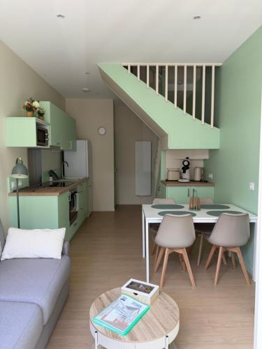 a living room with a couch and a table at Le refuge de Notre-Dame in Berck-sur-Mer