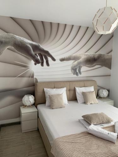 a painting of two hands jumping over a bed at Bavaro 50 by Alezzi Resort in Mamaia Sat/Năvodari