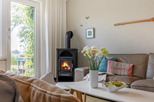 a living room with a couch and a fireplace at Ferienhaus Marienleuchte in Marienleuchte