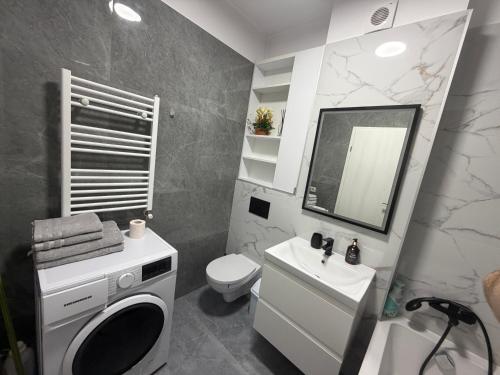 a bathroom with a sink and a toilet and a mirror at Royal Five Urban in Bucharest