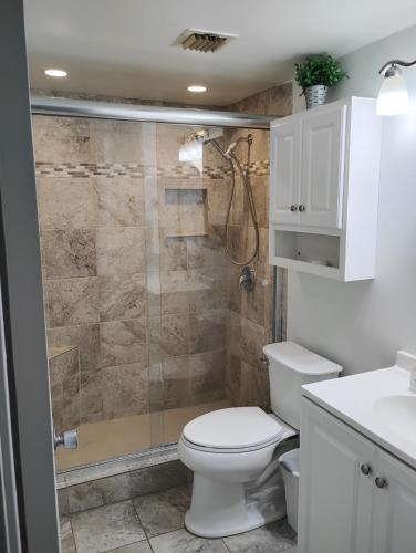 a bathroom with a toilet and a shower at Daytona Beach Hawaiian Inn in Daytona Beach