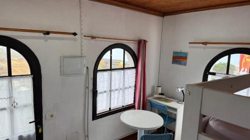 a bathroom with two windows and a table and a sink at 7 Calcosas in Valverde