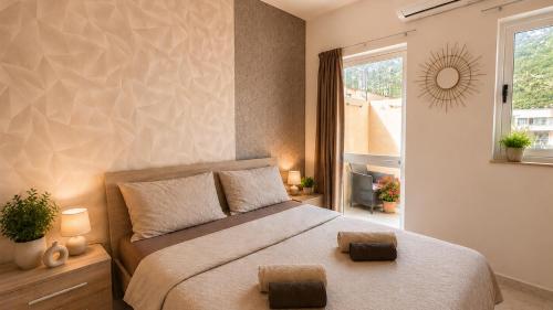 a bedroom with a large bed and a window at Arzella Apartments Xlendi, Premium 2BR, Bus Stop & Market Opposite in Xlendi