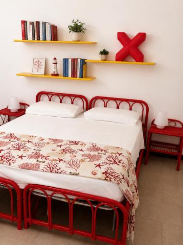 a bedroom with a bed with a red frame at Villa Adele Monopoli,Puglia in Faccia di Trippa