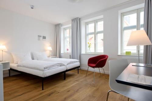 Postel nebo postele na pokoji v ubytování einzigartig - Das kleine Hotel im Wasserviertel