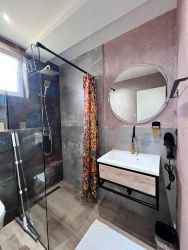 a bathroom with a sink and a mirror at Apartmani San Snova in Kotor-Varoš
