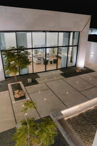 a large glass building with a tree in front of it at Hummingbird Dubai in Dubai