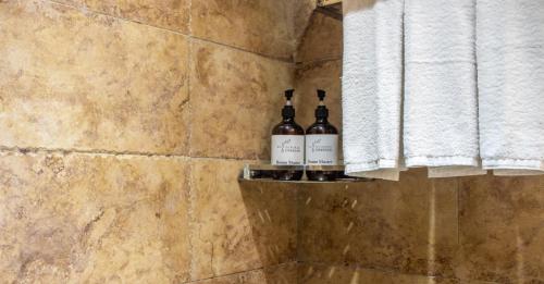 two bottles of wine sitting on a shelf in a bathroom at Zhangjiajie Yun Hai Hotel- Ancient Chinese Style Hotel,Tea Culture Experience, Realxing Class,Free Breakfast ,Local Travel Guide and Book Tickets, Gem Perporty in Zhangjiajie